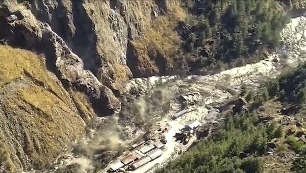 This frame grab from video provided by KK Productions shows a massive flood of water, mud and debris flowing at Chamoli District after a portion of Nanda Devi glacier broke off in Tapovan area of the northern state of Uttarakhand, India, Sunday, Feb.7, 2021. (KK Productions via AP) - Sputnik International