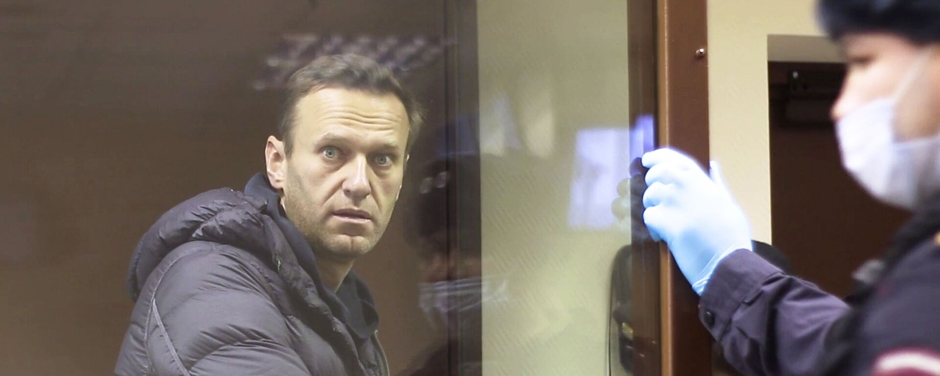 In this image made from video provided by the Babuskinsky District Court, Russian opposition leader Alexei Navalny stands in a cage during a hearing on his charges for defamation,  in the Babuskinsky District Court in Moscow, Russia, Friday, Feb. 5, 2021.  - Sputnik International, 1920, 01.03.2021