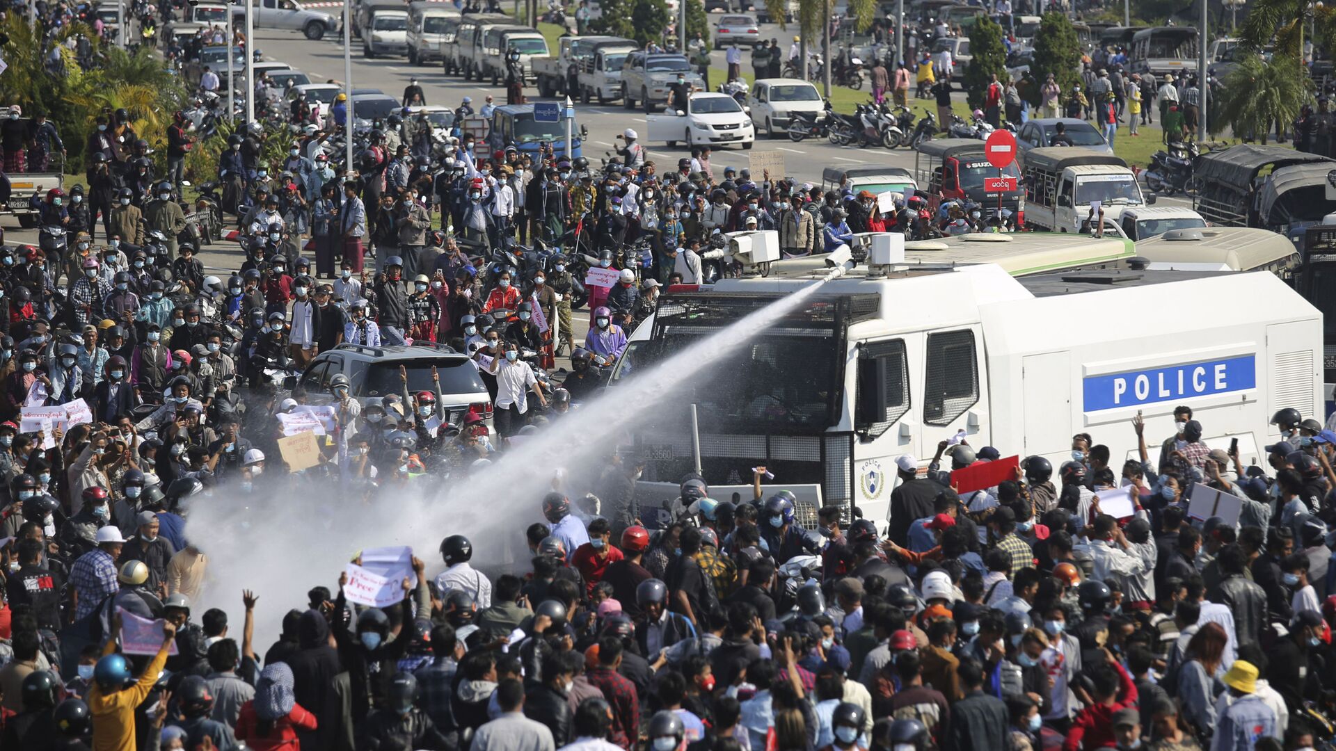 A police truck sprays water to a crowd of protesters in Naypyitaw, Myanmar on Monday, Feb. 8, 2021.  - Sputnik International, 1920, 04.08.2022