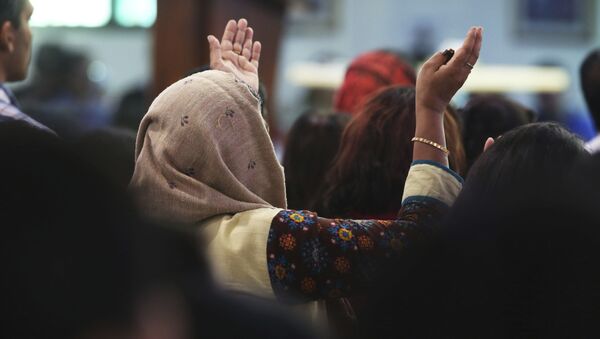In this Sunday, Jan. 20, 2019 photo, a woman prays during Mass at St. Mary's Catholic Church in Dubai, United Arab Emirates. The Catholic Church's parishioners in the UAE come from around the world and will offer an international welcome to Pope Francis Feb. 3 through Feb. 5, that marks the first ever papal visit to the Arabian Peninsula, the birthplace of Islam. The Catholic Church believes there are some 1 million Catholics in the UAE today. - Sputnik International