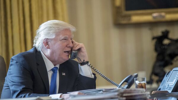 President Donald Trump speaks on the phone with Russian President Vladimir Putin, Saturday, Jan. 28, 2017, in the Oval Office at the White House in Washington - Sputnik International