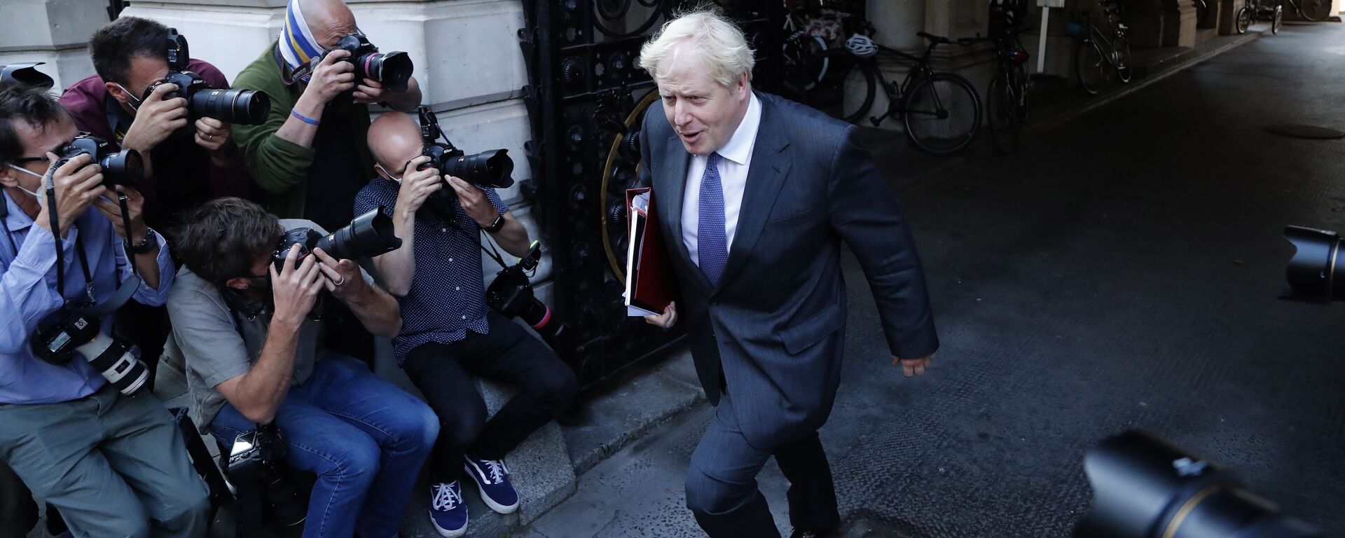 Britain's Prime Minister Boris Johnson walks past media photographers to his office in Downing Street after a cabinet meeting in London, Tuesday, Sept. 15, 2020. - Sputnik International, 1920, 04.06.2022