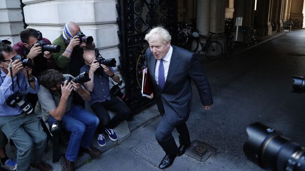 Britain's Prime Minister Boris Johnson walks past media photographers to his office in Downing Street after a cabinet meeting in London, Tuesday, Sept. 15, 2020. - Sputnik International