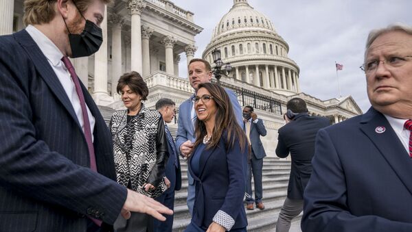 Rep. Lauren Boebert, R-Colo., centre, smiles after joining other freshman Republican House members for a group photo at the Capitol in Washington, Monday, 4 January 2021. Rep. Jerry Carl, R-Ala., is at right.  - Sputnik International
