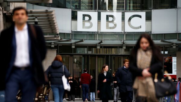 Pedestrians walk past a BBC logo at Broadcasting House in London, Britain January 29, 2020. - Sputnik International