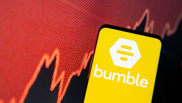 The Bumble logo is seen on a smartphone in front of a stock graph in this illustration taken February 11, 2021 - Sputnik International