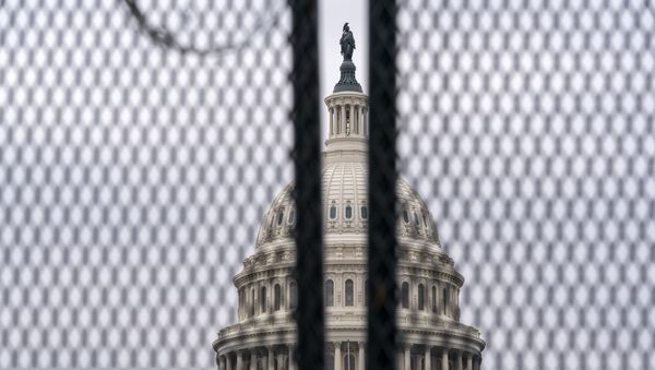 The U.S. Capitol is seen through a fence with barbed wire during the second impeachment trial of former President Donald Trump in Washington, Friday, Feb. 12, 2021.  - Sputnik International