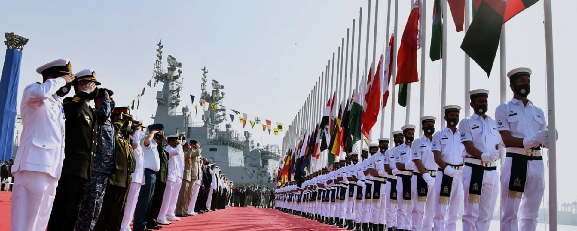 In this photo released by Pakistan Navy shows, military officials from differences countries salute during a flag hosting ceremony for multinational military exercise Aman or Peace, in Karachi, Pakistan, Friday, Feb. 12, 2021. Pakistan's Navy kicked off a five-day multinational military exercise in the Arabian Sea on Friday as part of Islamabad's years-long effort to bring security to the area, it said, although as usual regional archrival India was not invited. - Sputnik International, 1920, 14.02.2021