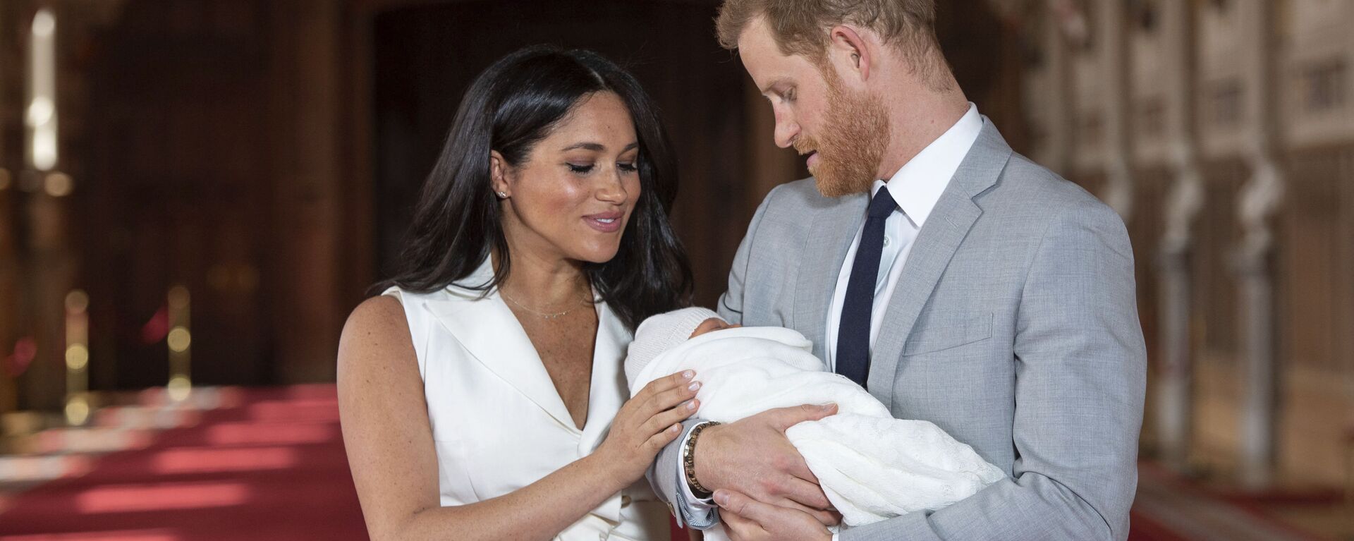 In this Wednesday May 8, 2019 file photo Britain's Prince Harry and Meghan, Duchess of Sussex, pose during a photocall with their newborn son Archie, in St George's Hall at Windsor Castle, Windsor, south England. The Duchess of Sussex has revealed that she had a miscarriage in July. Meghan described the experience in an opinion piece in the New York Times on Wednesday. She wrote: I knew, as I clutched my firstborn child, that I was losing my second. The former Meghan Markle and husband Prince Harry have a son, Archie, born in 2019.  - Sputnik International, 1920, 08.03.2021