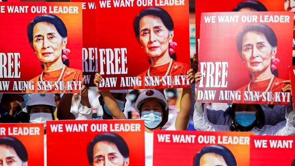 Demonstrators hold placards with the image of Aung San Suu Kyi during a protest against the military coup, in Naypyitaw, Myanmar, February 15, 2021.  - Sputnik International