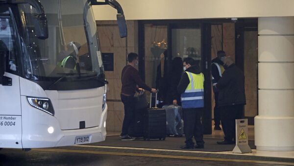 A coach delivers passengers to the Radisson Blu Edwardian Hotel, near Heathrow Airport, London, Monday Feb. 15, 2021 where they will remain during a 10 day quarantine period after returning to England from one of 33 red list countries - Sputnik International
