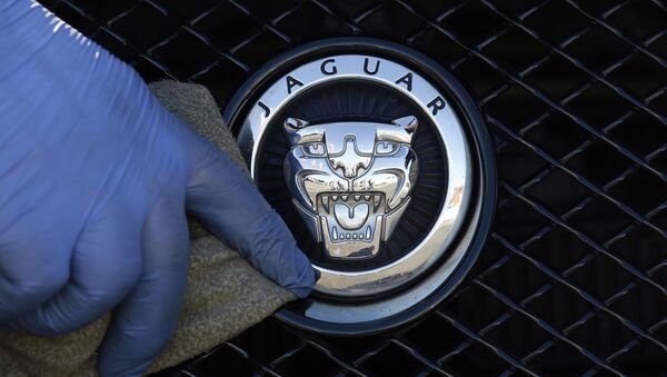 FILE - In this file photo dated Wednesday, Sept. 28, 2016, a worker polishes a Jaguar logo on a car at a Jaguar dealer outlet in London - Sputnik International