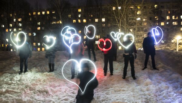 People draw hearts with their cellphones flashlights in support of jailed opposition figure Alexei Navalny in Moscow on 14 February.  - Sputnik International