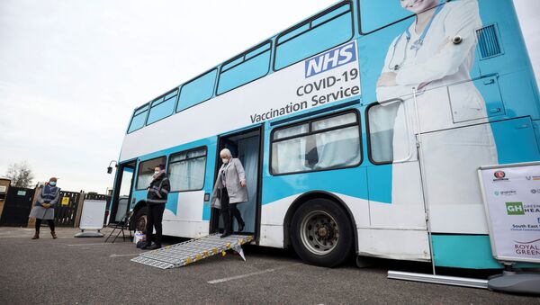 A person gets off a mobile vaccination centre for the coronavirus disease (COVID-19) after receiving the vaccine, in Thamesmead, London, Britain, February 14, 2021. - Sputnik International