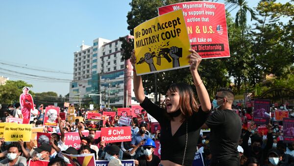 Demonstrators hold placards during a protest against the military coup in Yangon, Myanmar, 15 February 2021 - Sputnik International