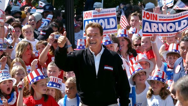  In this Oct. 5, 2003, file photo, Republican candidate for California governor Arnold Schwarzenegger walks up the steps to the state Capitol surrounded by children and waving to supporters during a campaign rally in Sacramento, Calif. California Gov. Gavin Newsom is facing a possible recall election as the nation's most populous state struggles to emerge from the coronavirus crisis - Sputnik International
