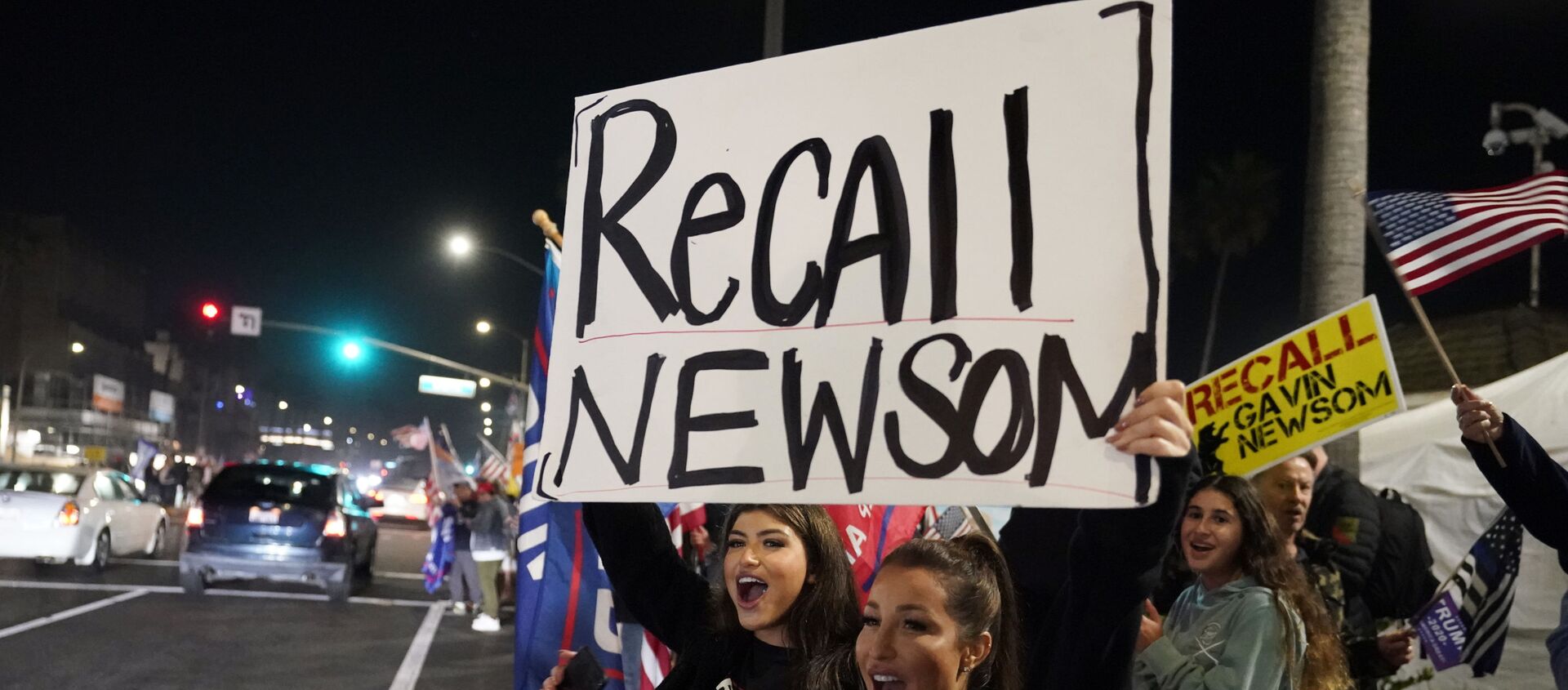 In this Nov. 21, 2020 file photo, demonstrators shout slogans while carrying a sign calling for the recall of Gov. Gavin Newsom during a protest against a stay-at-home order amid the COVID-19 pandemic in Huntington Beach, Calif - Sputnik International, 1920, 16.02.2021