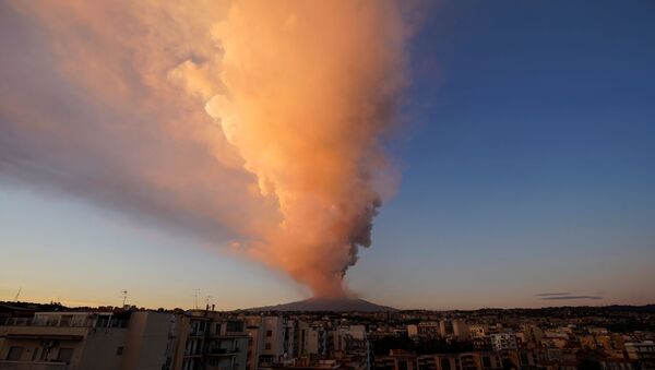 Mount Etna, Europe's most active volcano, spews volcanic ash as it leaps into action, seen from the village of Catania, Italy February 16, 2021. - Sputnik International