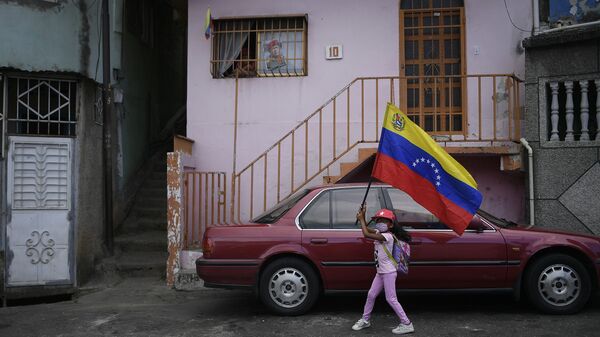 A girl flies a Venezuelan flag during the anniversary of his 1992 failed coup attempt by the late President Hugo Chavez at the 23 de Enero neighborhood of Caracas, Venezuela, Thursday, Feb. 4, 2021. - Sputnik International