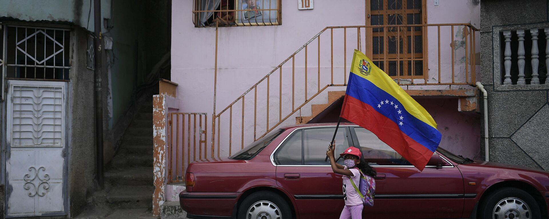 A girl flies a Venezuelan flag during the anniversary of his 1992 failed coup attempt by the late President Hugo Chavez at the 23 de Enero neighborhood of Caracas, Venezuela, Thursday, Feb. 4, 2021. - Sputnik International, 1920, 16.02.2021