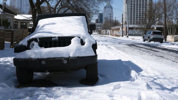 A parked Jeep is covered in snow Tuesday, Feb. 16, 2021, in Austin, Texas - Sputnik International
