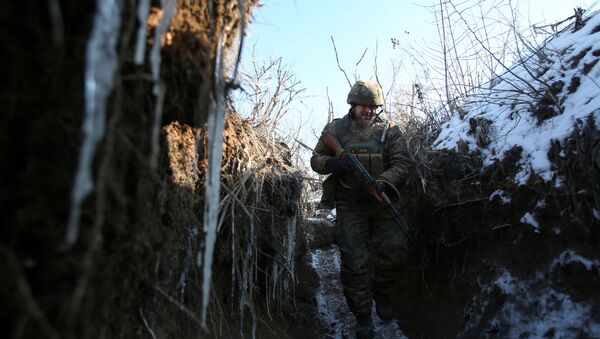 An Ukrainian serviceman stands in position on the front line with the Self-defense fighters of the Donetsk People's Republic on February 16, 2021  - Sputnik International