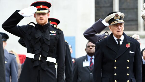 Britain's Prince Harry (L) salutes as he stands alongside his grandfather Britain's Prince Philip, Duke of Edinburgh, during their visit to the Field of Remembrance at Westminster Abbey in central London on November 10, 2016. - Sputnik International