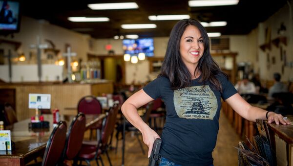 In this file photo owner Lauren Boebert poses for a portrait at Shooters Grill in Rifle, Colorado on April 24, 2018. - A Republican member of the US Congress raised eyebrows on February 18, 2021 when she appeared at a Zoom committee meeting with an arsenal of guns strategically displayed in her background. - Sputnik International