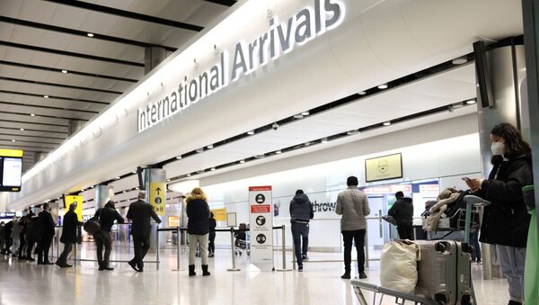 Travellers stand at Terminal 2 of Heathrow Airport, amid the coronavirus disease (COVID-19) outbreak in London, Britain February 14, 2021 - Sputnik International