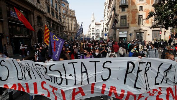 Demonstrators hold a banner during a protest in support of Catalan rapper Pablo Hasel, after he was given a jail sentence on charges of glorifying terrorism and insulting royalty in his songs, in Barcelona, Spain, February 19, 2021 - Sputnik International