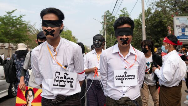 Demonstrators protest against the military coup in Yangon, Myanmar, February 19, 2021. - Sputnik International