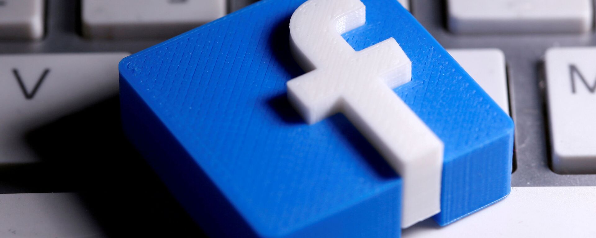 A 3D-printed Facebook logo is seen placed on a keyboard in this illustration taken March 25, 2020.  - Sputnik International, 1920, 05.05.2021