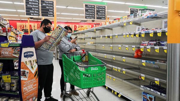 Shoppers stand at nearly empty snack section in Fiesta supermarket after winter weather caused food and clean water shortage in Houston, Texas, U.S. February 19, 2021 - Sputnik International