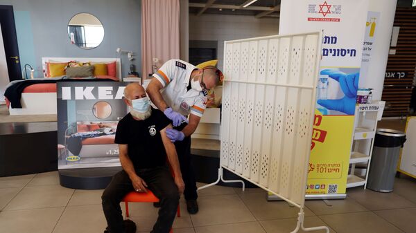 A man receives a vaccination against the coronavirus disease (COVID-19) in an IKEA store in Rishon Lezion, Israel, 22 February 2021.  - Sputnik International