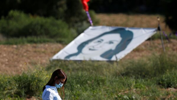 FILE PHOTO: A woman walks past a banner depicting anti-corruption journalist Daphne Caruana Galizia during a commemoration at the site where the journalist was assassinated with a car bomb in 2017, in Bidnija, Malta, October 16, 2020.  - Sputnik International