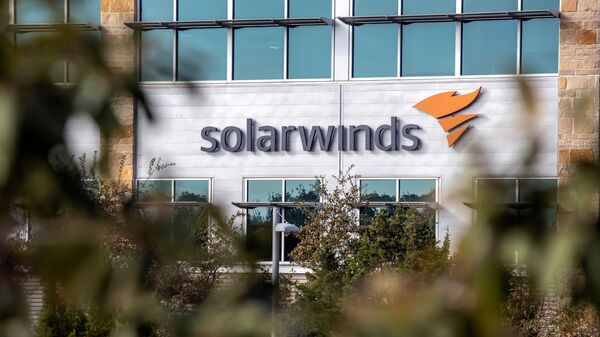 FILE PHOTO: The SolarWinds logo is seen outside its headquarters in Austin, Texas, U.S., December 18, 2020.  - Sputnik International