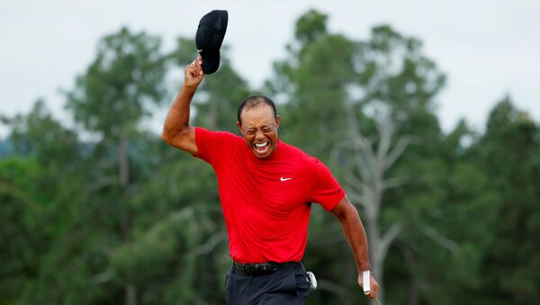 FILE PHOTO: Golf - Masters - Augusta National Golf Club - Augusta, Georgia, U.S. - April 14, 2019 - Tiger Woods of the U.S. celebrates on the 18th hole after winning the 2019 Masters. REUTERS/Brian Snyder/File Photo - Sputnik International