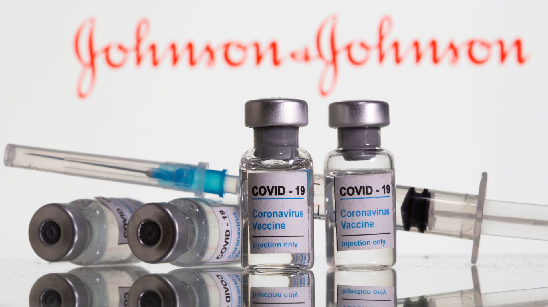 Vials labelled COVID-19 Coronavirus Vaccine and sryinge are seen in front of displayed Johnson&Johnson logo in this illustration taken, February 9, 2021 - Sputnik International, 1920, 24.02.2021