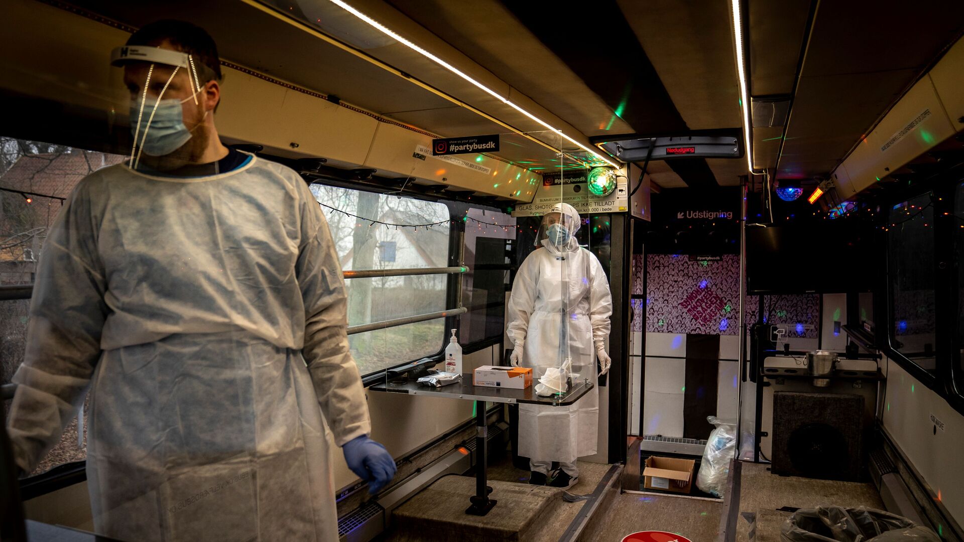 Healthcare workers wait in the Partybus, where people can listen to music while being tested for the coronavirus disease (COVID-19), in Ishoej, Denmark February 23, 2021 - Sputnik International, 1920, 21.05.2021
