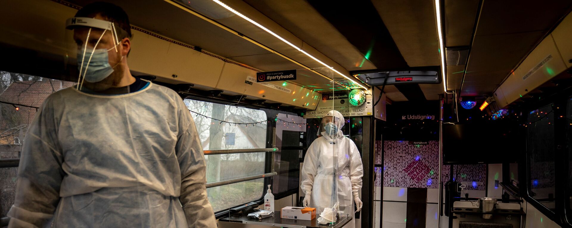 Healthcare workers wait in the Partybus, where people can listen to music while being tested for the coronavirus disease (COVID-19), in Ishoej, Denmark February 23, 2021 - Sputnik International, 1920