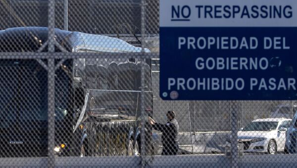 A bus leaves a closed border facility as migrants subject to a Trump-era asylum restriction program were expected to begin entry into the United States at the San Ysidro border crossing with Mexico, in San Diego, California, U.S., February 19, 2021 - Sputnik International