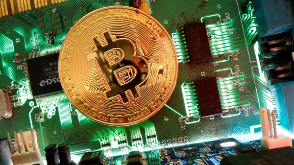 Representation of the virtual currency Bitcoin is seen on a motherboard in this picture illustration taken April 24, 2020 - Sputnik International