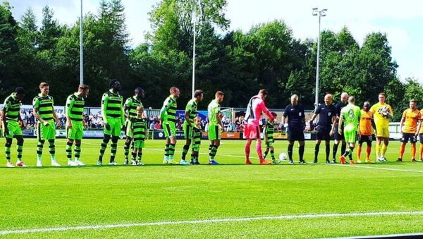 Forest Green Rovers players line up ahead of a match at their stadium in England - Sputnik International