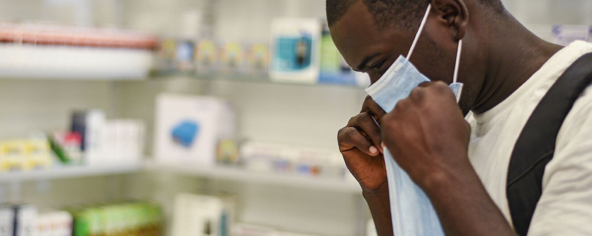 FILE — In this Feb. 6, 2020, file photo, a man tries on a face mask at a pharmacy in Kitwe, Zambia. Facing financial difficulties aggravated by the coronavirus pandemic, the southern African nation of Zambia seems to be headed for a default on debt owed to private investors - Sputnik International, 1920