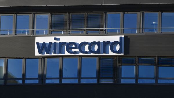 The logo of German payments provider Wirecard is seen at a building of the company's headquarters in Aschheim near Munich, southern Germany, on November 18, 2020 as the first creditors' event after the financial scandal takes place in Munich. - Sputnik International