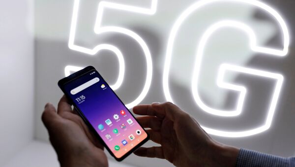 FILE PHOTO: Person checks out the new Xiaomi Mi 9 mobile phone ahead of the Mobile World Congress (MWC 19) in Barcelona - Sputnik International
