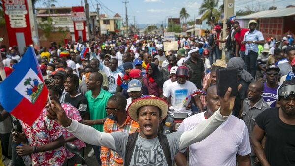 People protest to demand the resignation of Haitian President Jovenel Moise in Port-au-Prince, Haiti, Sunday, Feb. 28, 2021. The opposition is disputing the mandate of President Moise whose term they claim ended on Feb. 7, but the president and his supporters say his five-year term only expires in 2022. - Sputnik International