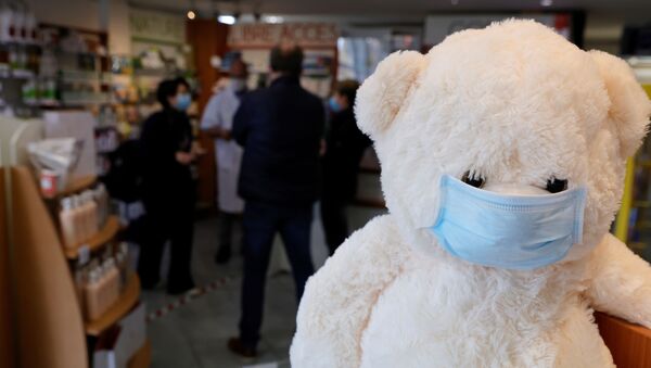 A teddy bear, wearing a protective face mask, is seen in a pharmacy in Gouzeaucourt amid the coronavirus disease (COVID-19) outbreak in France, February 25, 2021. - Sputnik International