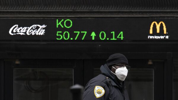 A security guard walks by a stock ticker displaying the cost of Coca-Cola shares at the New York Stock Exchange, Tuesday, Feb. 23, 2021. - Sputnik International