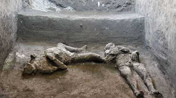 The casts of what are believed to have been a rich man and his male slave fleeing the volcanic eruption of Vesuvius nearly 2,000 years ago, are seen in what was an elegant villa on the outskirts of the ancient Roman city of Pompeii destroyed by the eruption in 79 A.D., where they were discovered during recents excavations, Pompeii archaeological park officials said Saturday, Nov. 21, 2020 - Sputnik International